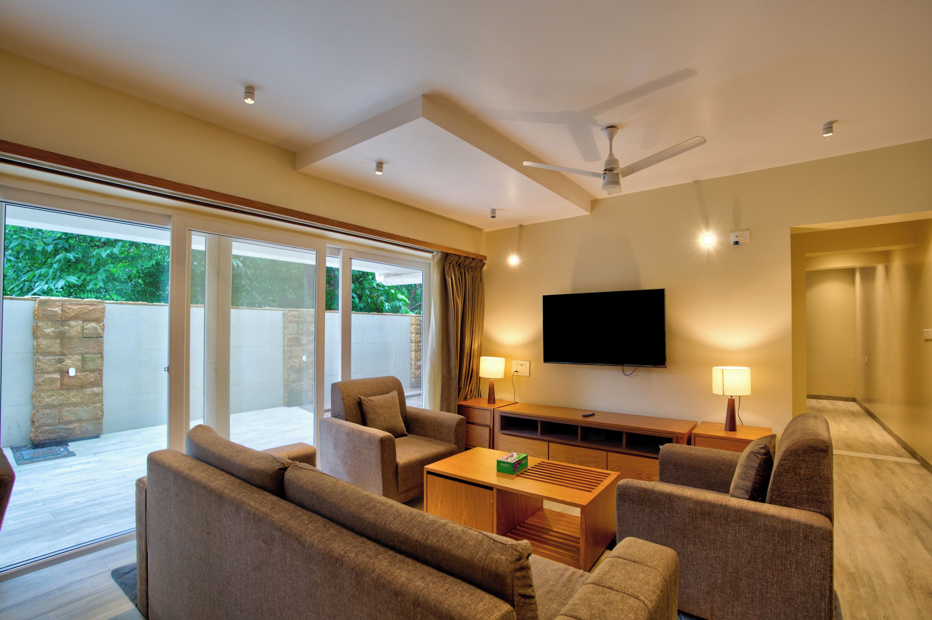 Premium Apartment, Patio, Pool View | Living area | TV