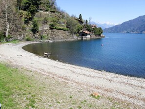 A lakeside view with a small building on a hillside, a clear sky, and mountains in the background. - Beautiful private villa for 6 guests with A/C, WIFI, terrace and pets allowed (San Siro)