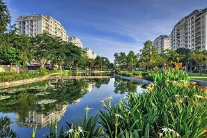 Escape to a serene urban retreat surrounded by lush greenery and a tranquil pond.