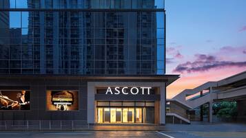 A modern building with a glass facade and the name "ASCOTT" prominently displayed.