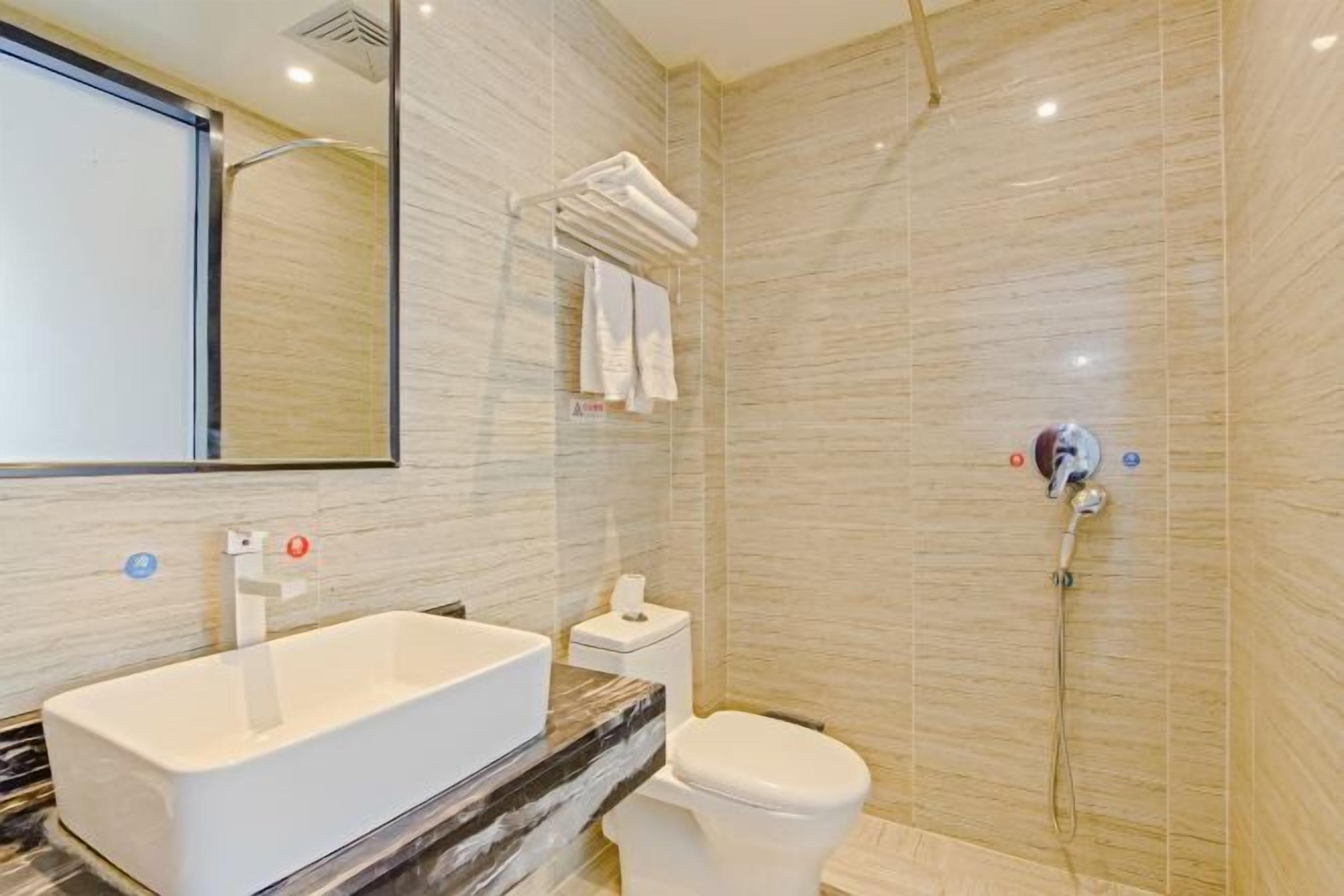 Een moderne badkamer met een groot bad, een toilet en een douche.