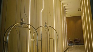 A hallway with a modern design, featuring a metallic structure and a wooden wall. - Kebayoran Park Hotel (South Jakarta)