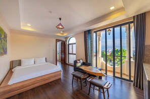 Executive Quadruple Room | Minibar, desk, laptop workspace, blackout drapes