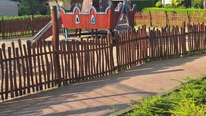 A wooden play structure with a red roof and a small tower. - Private Sanctuary/Zen Den/nature lovers (Voorthuizen)