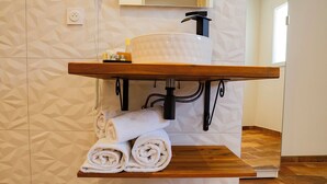 A bathroom with a wooden vanity, a towel rack, and a mirror. - RANDOM LISTING (Sainte-Tulle)