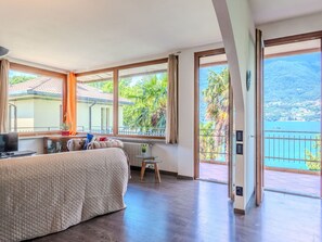 Relax in this serene bedroom with a large bed, mountain views, and a balcony.