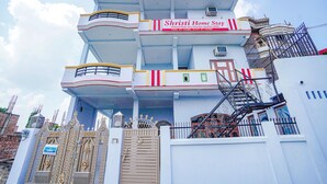 A multi-story building with a sign for 'fab hotels' and 'Shristi Home Stay'. - Fabhotel Shristi Homestay (Faizabad)