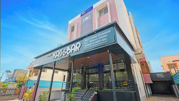 A hotel with a sign indicating it offers a multi-culine restaurant, A/C non-smoking rooms, and a banquet & party hall. - FabHotel Kas (Chhatrapati Sambhajinagar)