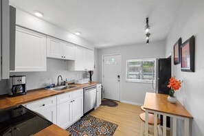 Fridge, stovetop, dishwasher, coffee/tea maker