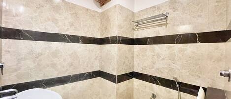 A bathroom with a bathtub, toilet, and shower.
