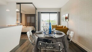 Ett modernt hotellrum med en matplats, en säng och utsikt över omgivningarna.
