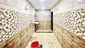 Un bagno moderno con pareti in piastrelle esagonali, pavimento in legno e un lavabo centrale.