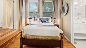 A neatly arranged bedroom with a large bed, bedside lamps, and a view through the window. - Washington, DC's Finest Address (Washington)