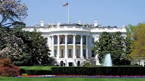 A large, white, neoclassical building with a central dome and columns, surrounded by well-manicured gardens and a flagpole. - Washington, DC's Finest Address (Washington)