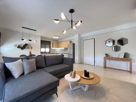 Deluxe Apartment | Living area | 49-inch Smart TV with digital channels