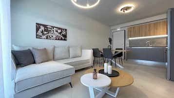 Deluxe Apartment | Living area | 49-inch Smart TV with digital channels