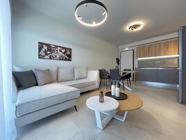 Deluxe Apartment | Living area | 49-inch Smart TV with digital channels