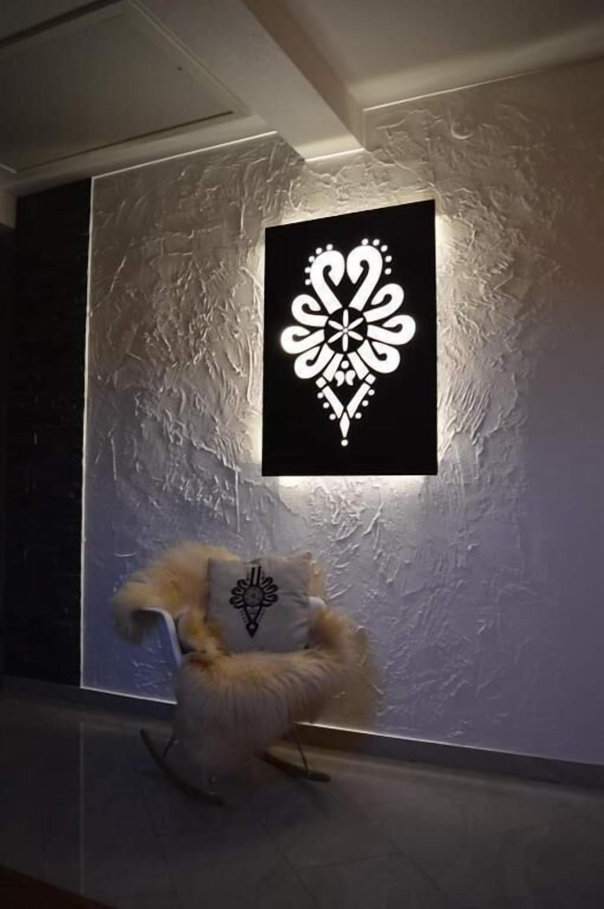 A modern interior with a textured wall and a framed artwork.