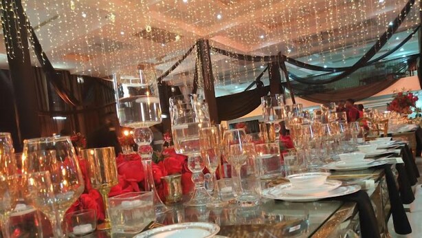 A banquet hall with tables set for a formal event, featuring clear glassware and elegant table settings. - Yewa Frontier Hotel (Ibese)