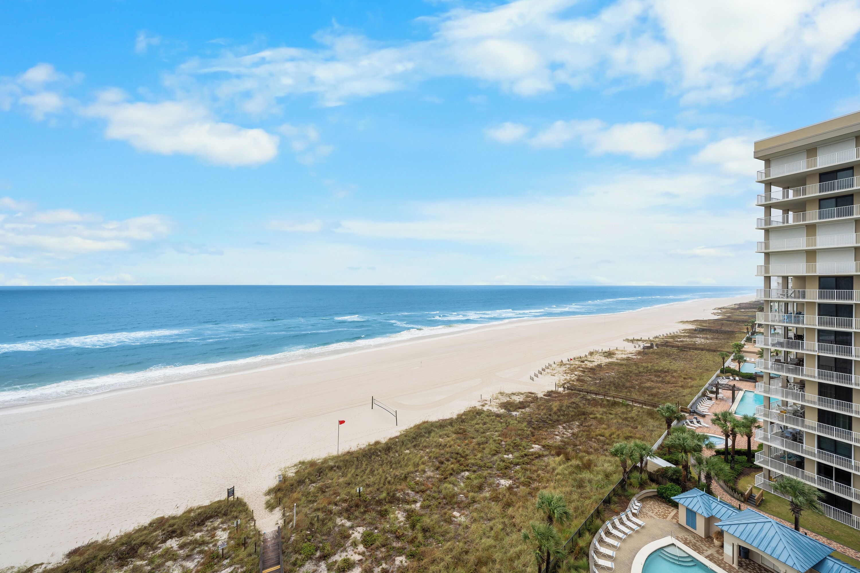 A beachfront hotel with a pool, beach access, and ocean views.
