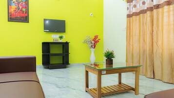 Family Apartment, City View | Living area | TV