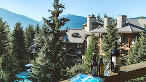A resort with a pool, a sign for Drift, and bottles of wine on a table.