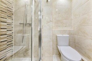 Appartement | Badkamer | Een douche, een haardroger, handdoeken