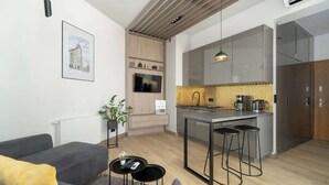 A modern apartment with a living room, kitchen, and dining area. - Stylish Studio in the Center | Air Conditioning, Balcony (Poznan)