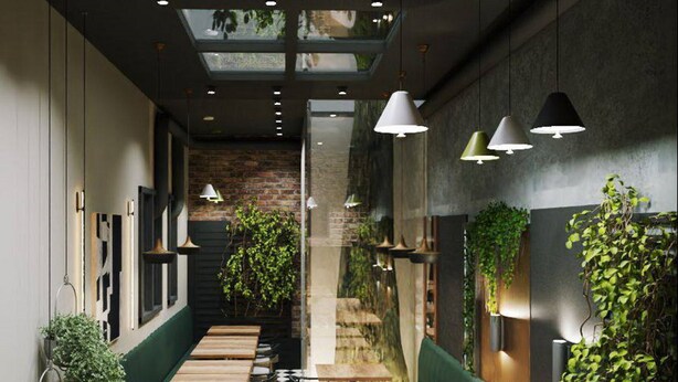 A restaurant with a checkered floor, wooden tables, green booths, pendant lighting, and plants. - Twelve Inn Hotel (Baku)