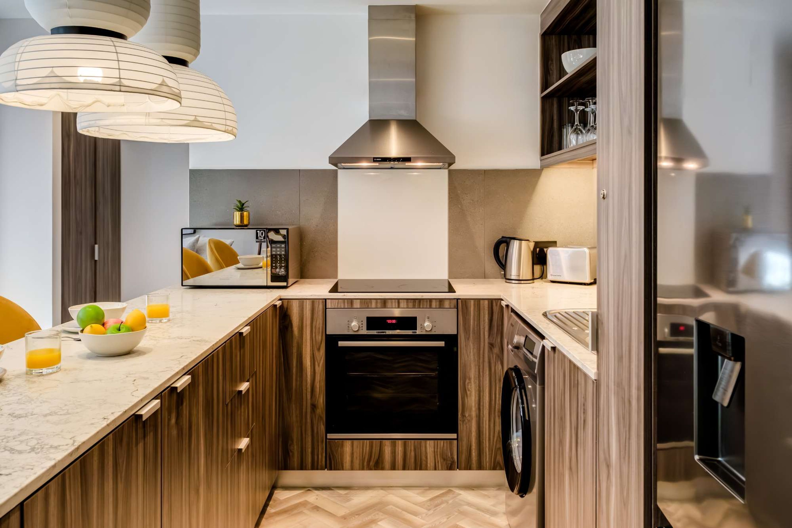 A compact kitchen with a built-in oven, a microwave, and a coffee maker.