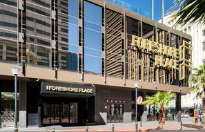 A modern building with a prominent 'FORESHORE PLACE' sign. - Stylish Urban Retreat at City Suite 904 (Cape Town)