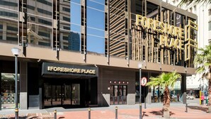 A modern building with a prominent sign reading "FORESHORE PLACE". - Upscale Urban Haven at City Suite 906 (Cape Town)