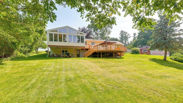 A two-story house with a large deck and a covered porch. - 1440 Getaway w/ Yard & Deck ~ 16 Mi to Rochester (Rush)