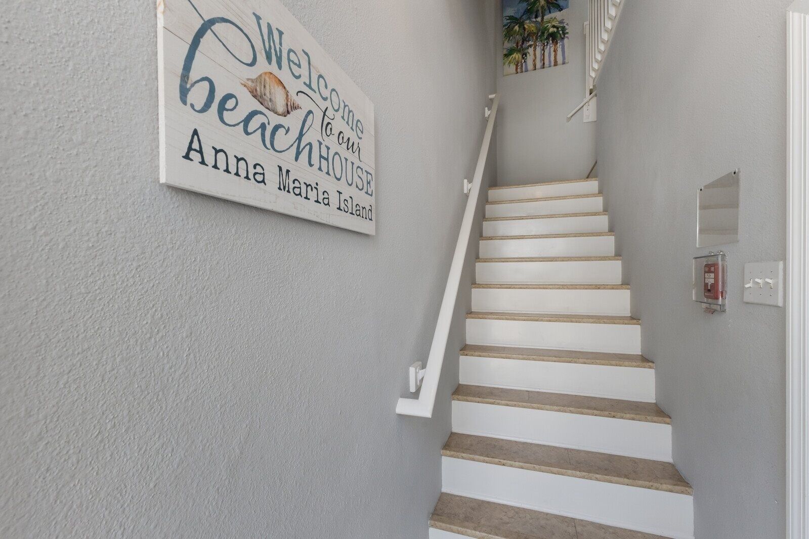 A staircase with a sign reading "Welcome to our Beachhouse Anna Maria Island."