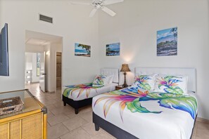 A hotel room with two beds, a ceiling fan, and artwork on the walls. - Wailea Ekahi, #19a 2 Bedroom Condo by RedAwning (Kihei)