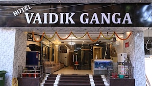 The entrance of Hotel Vaidik Ganga with marble steps, a reception desk, and a decorative garland. - HOTEL VAIDIK GANGA  (rishikesh)