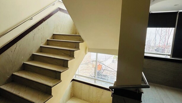 A staircase with a modern design, leading to an upper floor. - HOTEL SMART STAY (New Delhi)