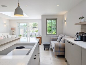 Enjoy meals and relaxation in this kitchen with a central island and adjacent seating area.
