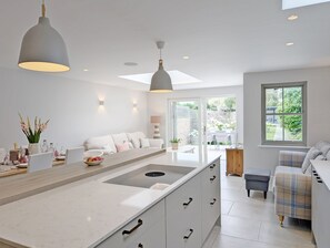 Enjoy meals and casual gatherings in this kitchen with a central island, pendant light, and seating area.