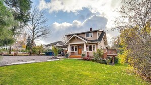 A two-story house with a front porch, a covered entryway, and a small deck. - Sequoia Vacation Rental (Milton)
