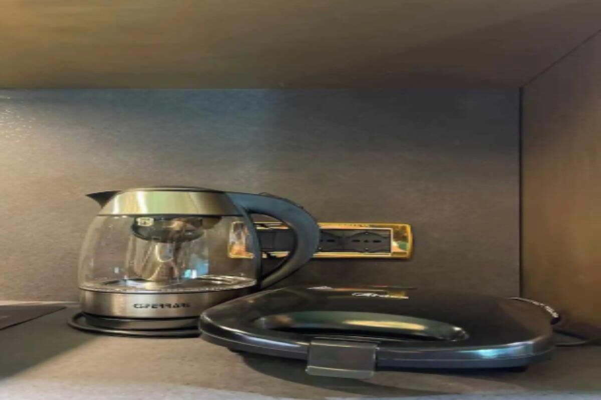 A coffee maker and a kettle on a countertop.