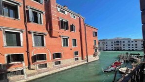 A canal with buildings on one side and a clear blue sky. - Charming Canal View Apartment in Historic Venetian Palace







 (Venezia)