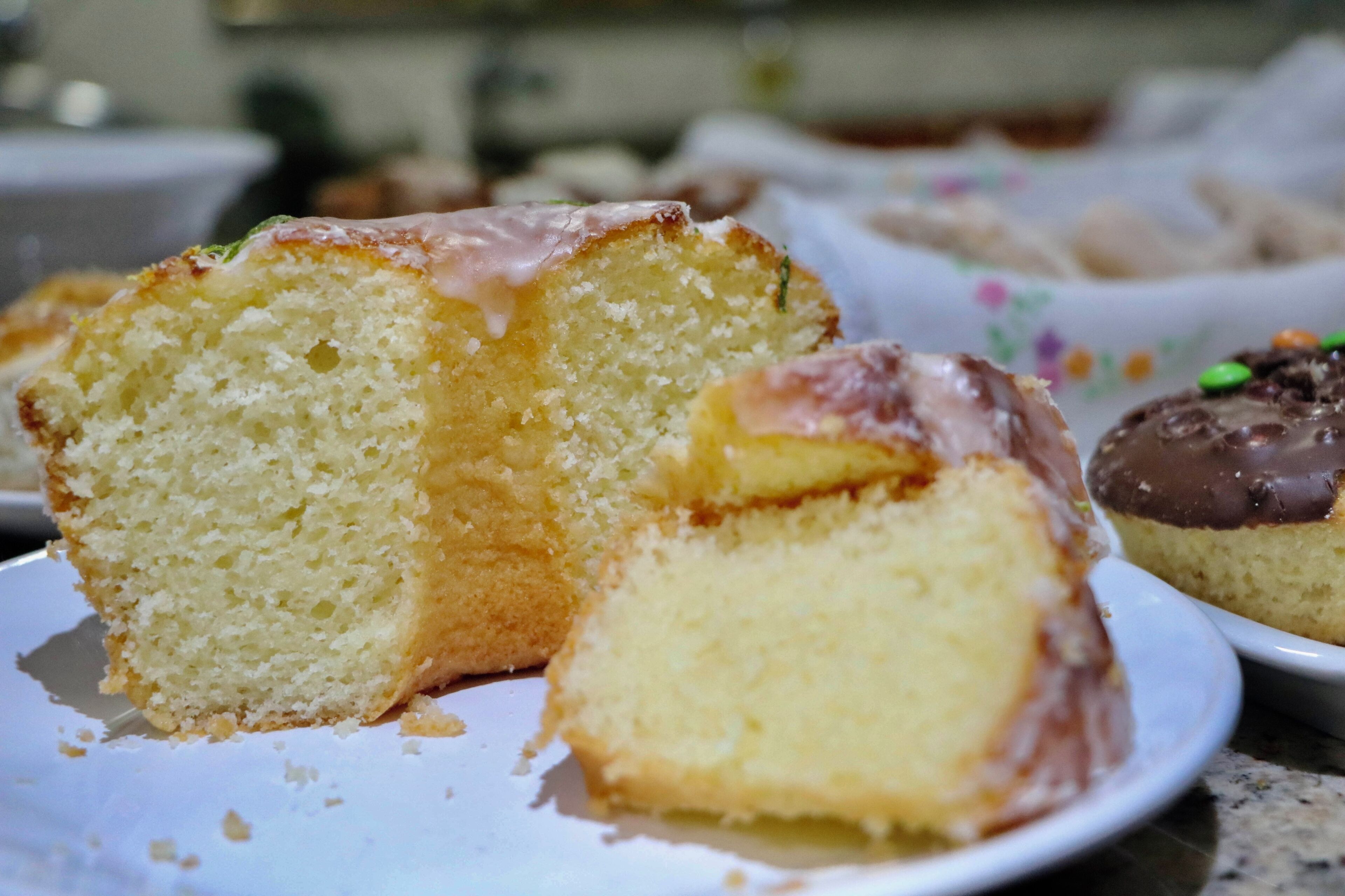 A slice of cake with icing on a plate.