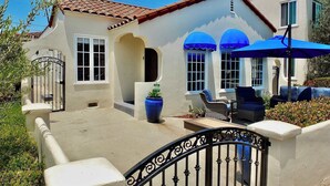 A house with a tiled roof, a gated entrance, and outdoor furniture. - Belmont Shore Beach House (Long Beach)