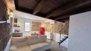 A modern interior with a white sofa, a kitchen with a red refrigerator, and a staircase. - Alghero my Love (Alghero)
