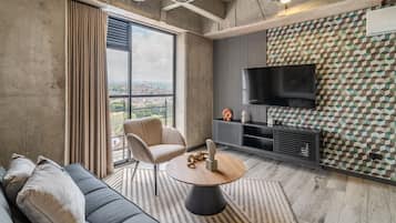 Comfort Apartment | Living area | 30-inch TV with cable channels