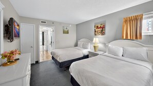 A hotel room with two beds, a desk with a lamp, a TV, and artwork on the walls. - Atlantica 903, Oceanfront Stay, Myrtle Beach Rental (Myrtle Beach)