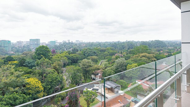 A high-rise building with a view of a cityscape and surrounding greenery. - 2 Bedroom - Spacious and Modern - Riverside One (Nairobi)
