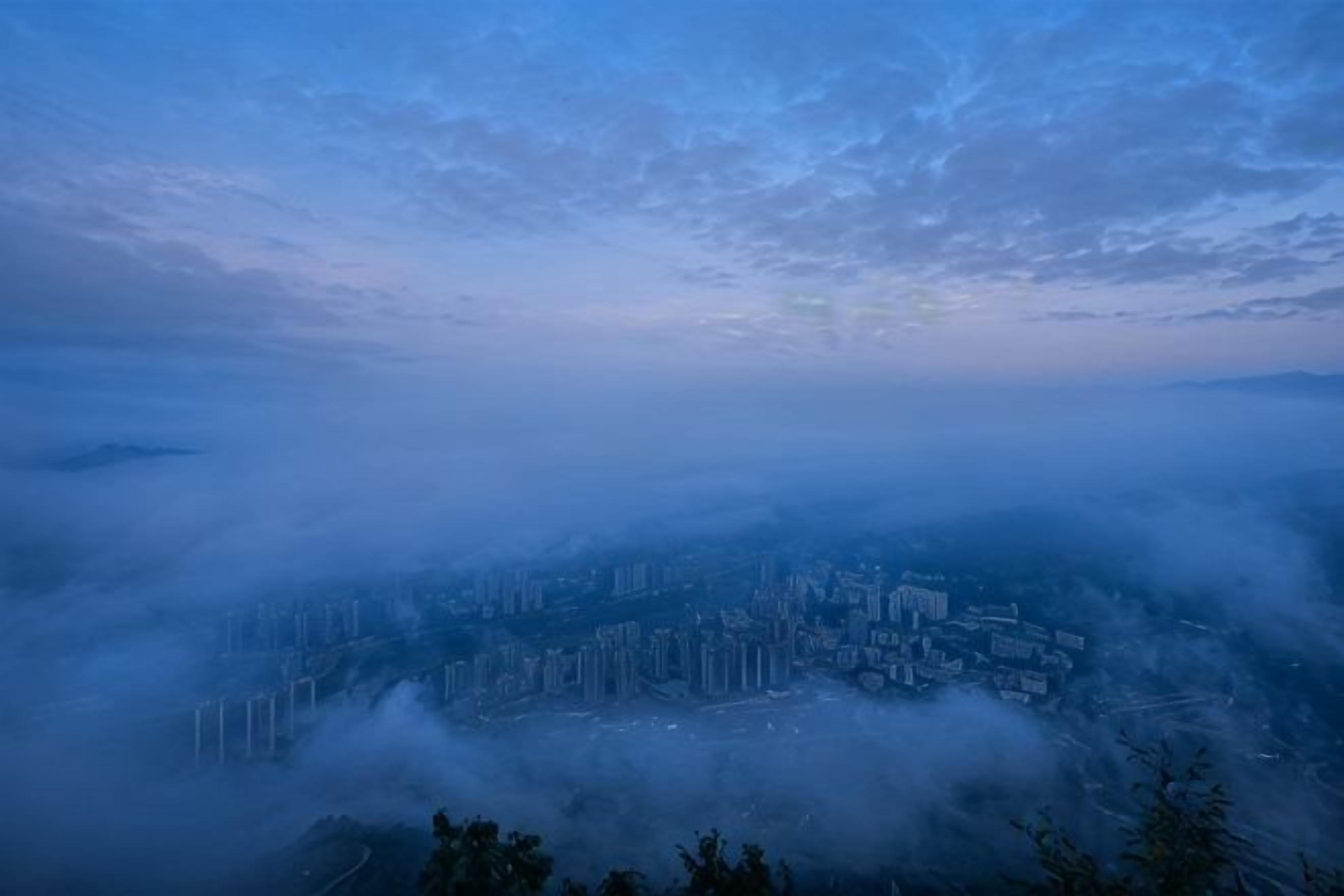 A cityscape with buildings partially obscured by fog.