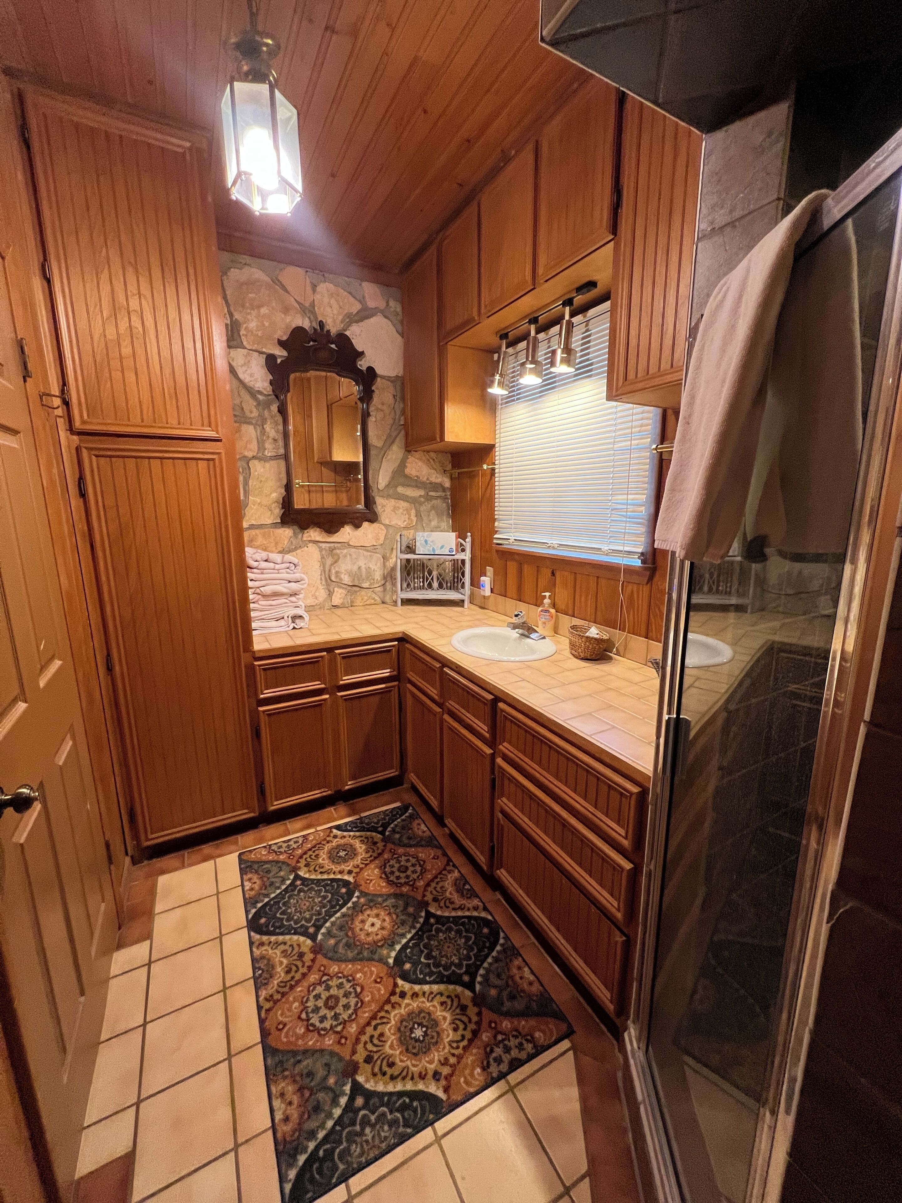 Shower stall with towels provided.